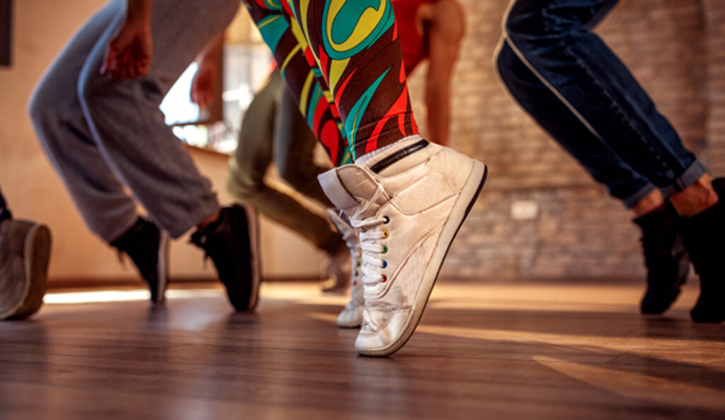 Closeup of feet on the dance studio floor at Sanctuary Body