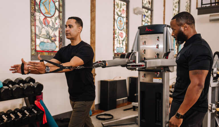 Sanctuary Body trainer guiding his client's exercise