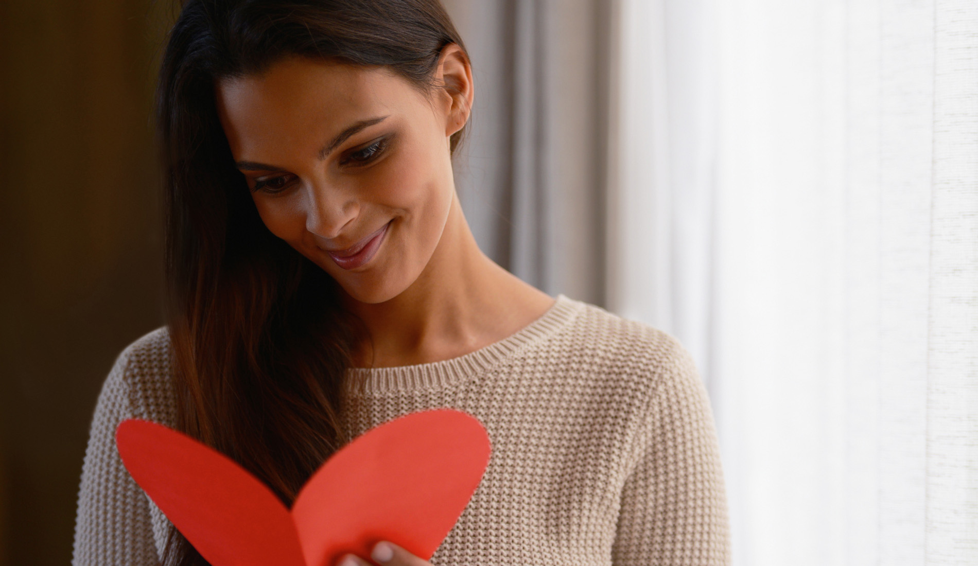 Woman opening a gift certificate from Sanctuary Body in Baltimore